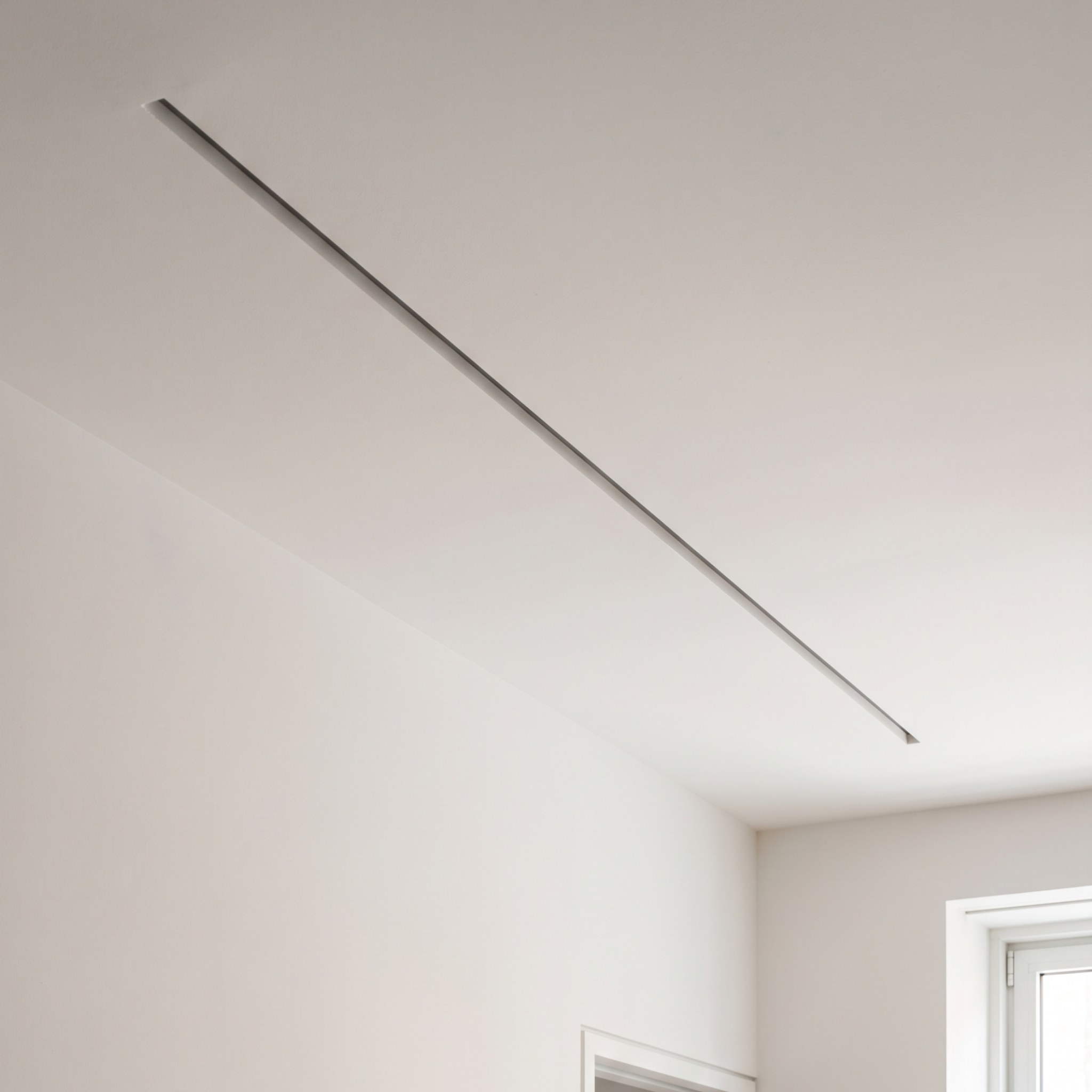 Concealed linear diffuser in a minimal apartment ceiling